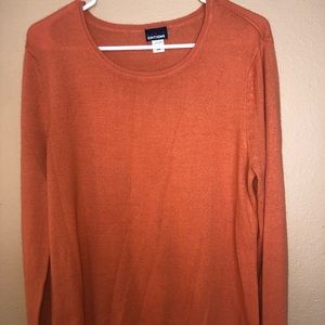 Pretty, soft orange sweater, longer length.